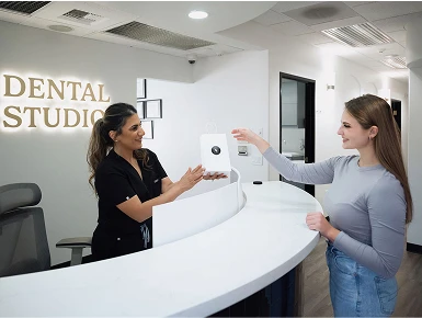 Dr. Zeidan handing a gift bag to a patient